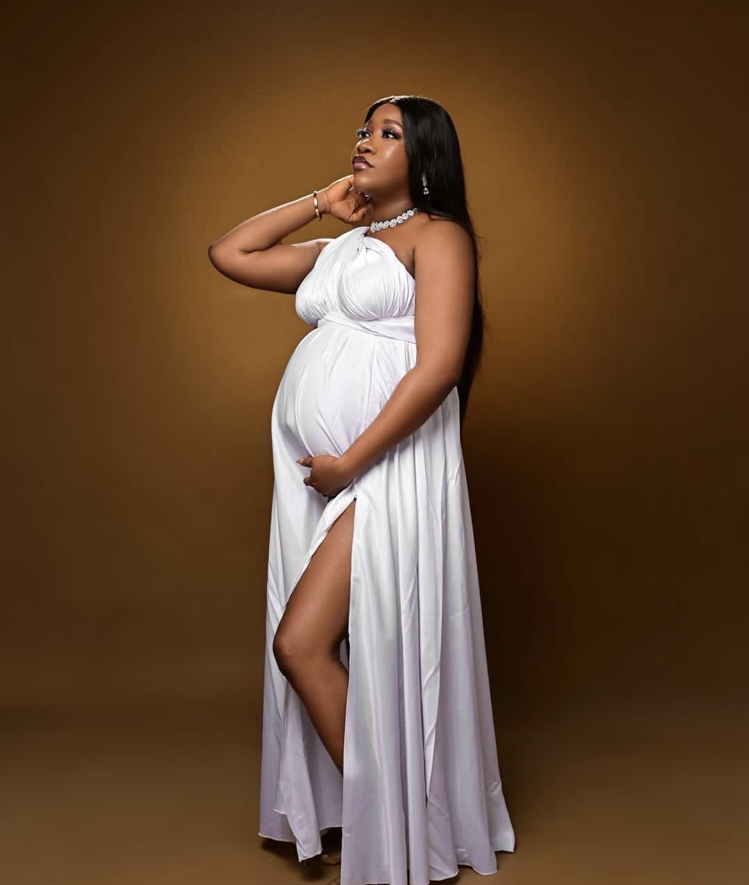 Pregnant woman in white dress, birth tourism service